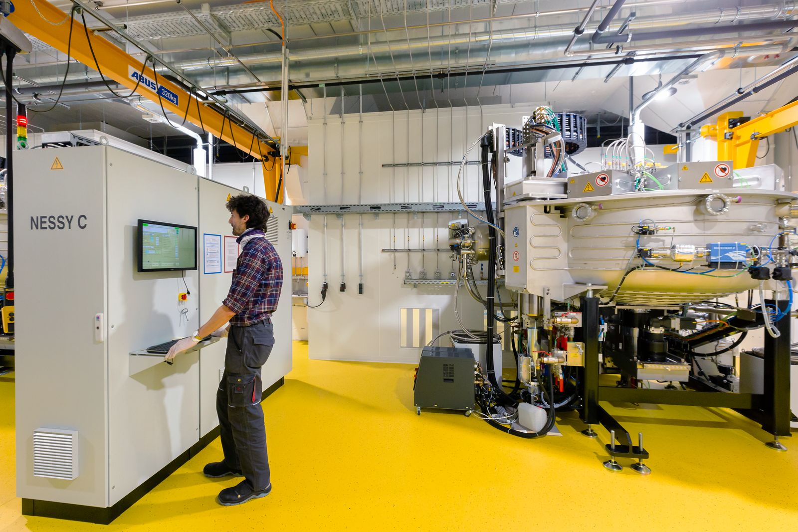 Ernesto Roa Romero, service engineer at optiX fab, checks the parameters on one of the NESSYs in the machine room.