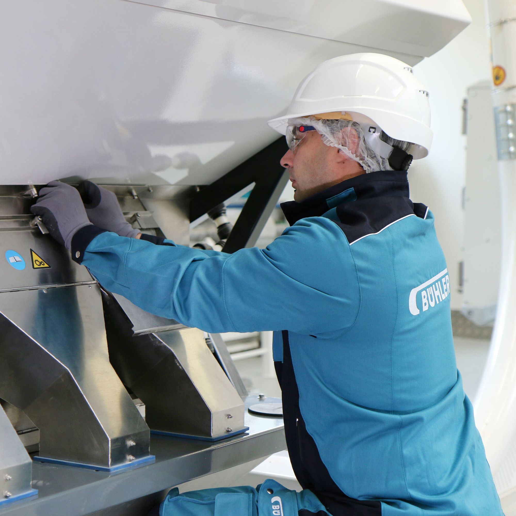 Bühler employee opening the chutes of an optical sorter SORTEX