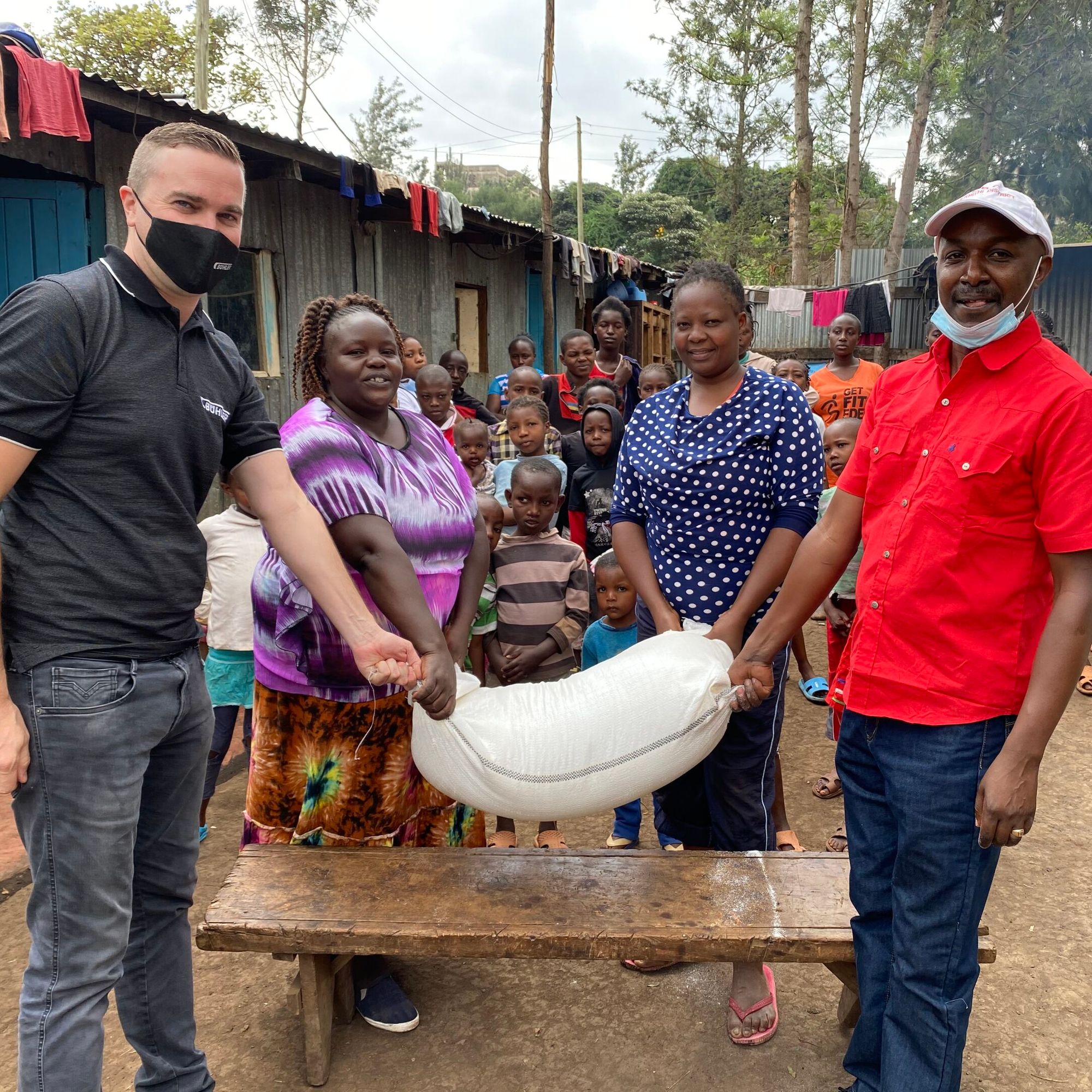 Stefan Lutz, Head of the African Milling School, donates fortified maize flour to the children's homes.