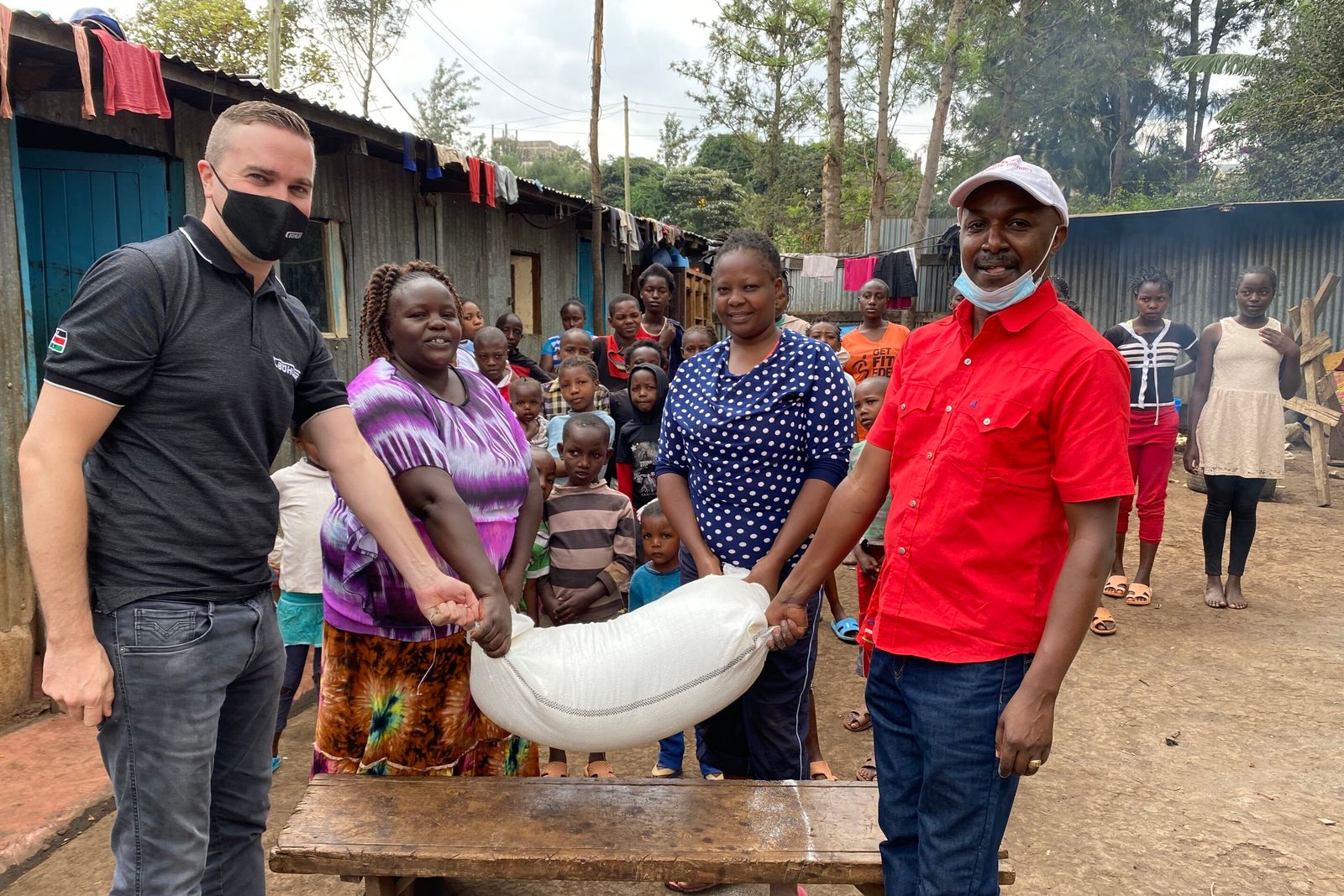 Stefan Lutz, Head of the African Milling School, donates fortified maize flour to the children's homes.