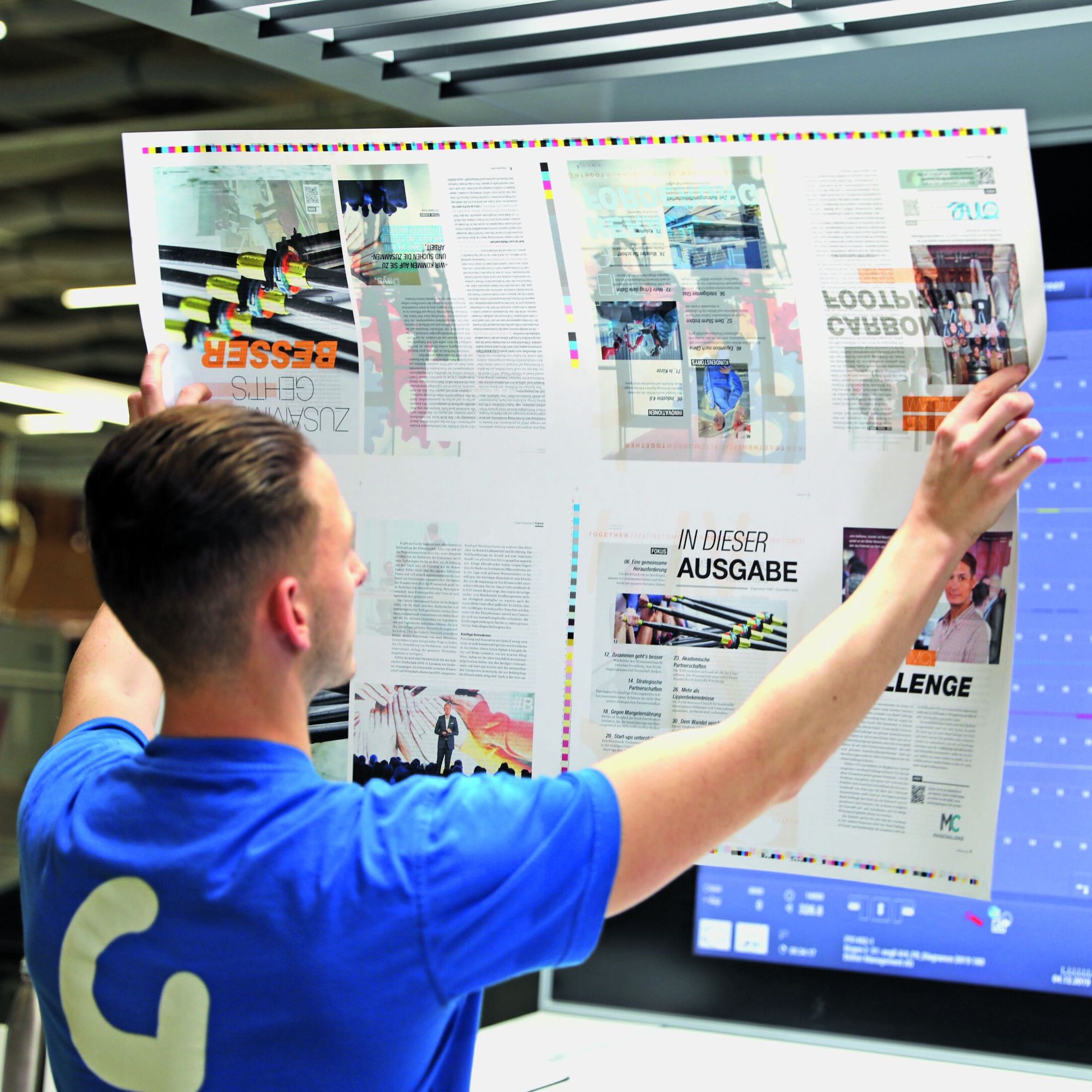 man looking at print out of magazine