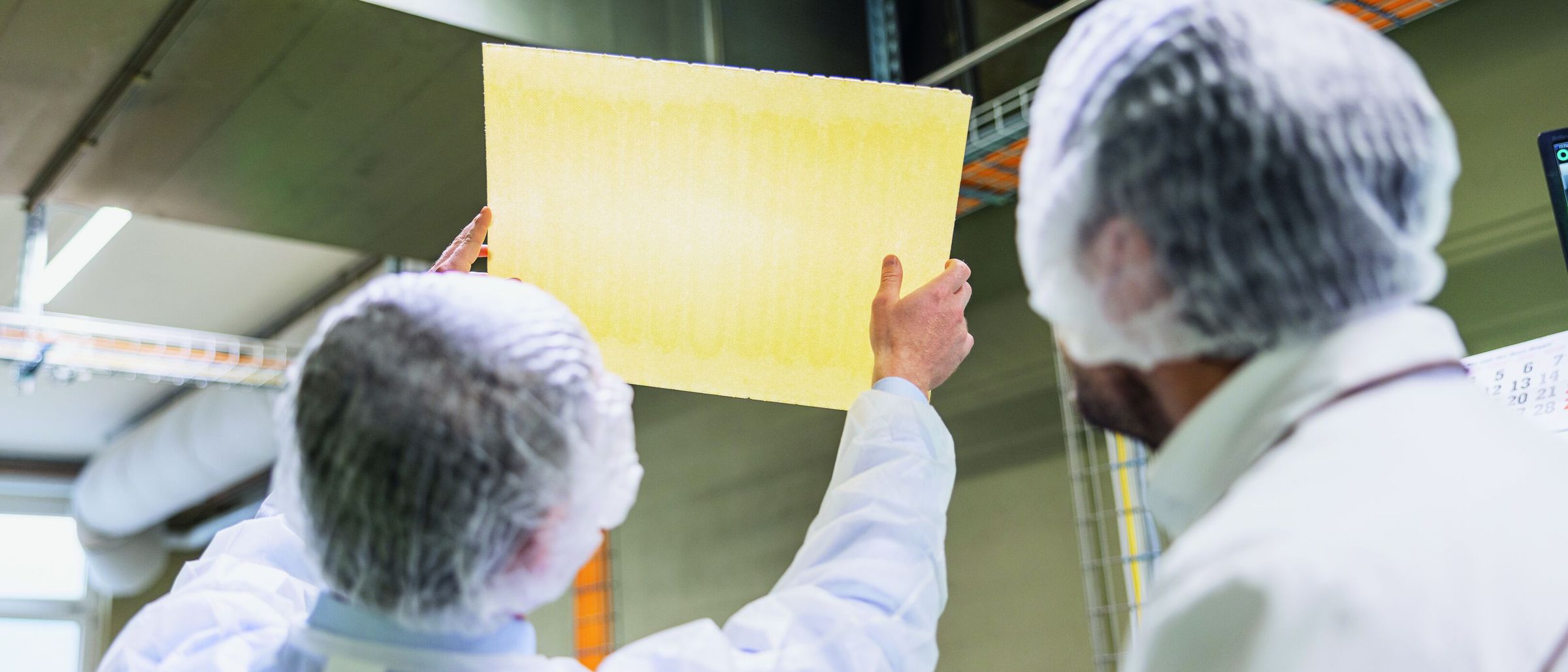 Christian Salvatori, Sales Manager at Bühler, and Pascal Grin, COO at Kägi, check the quality of the wafer sheets. 