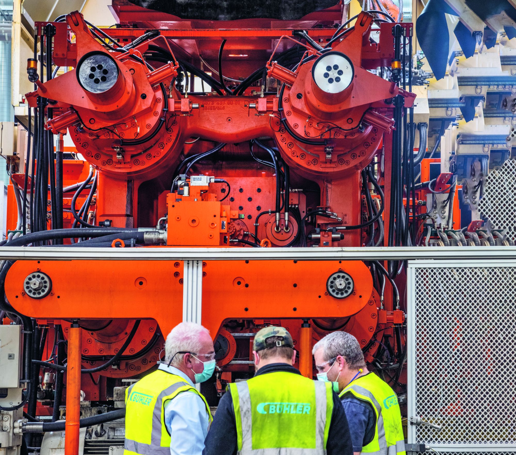 View of Carat die casting cell with 3 people standing in front of it