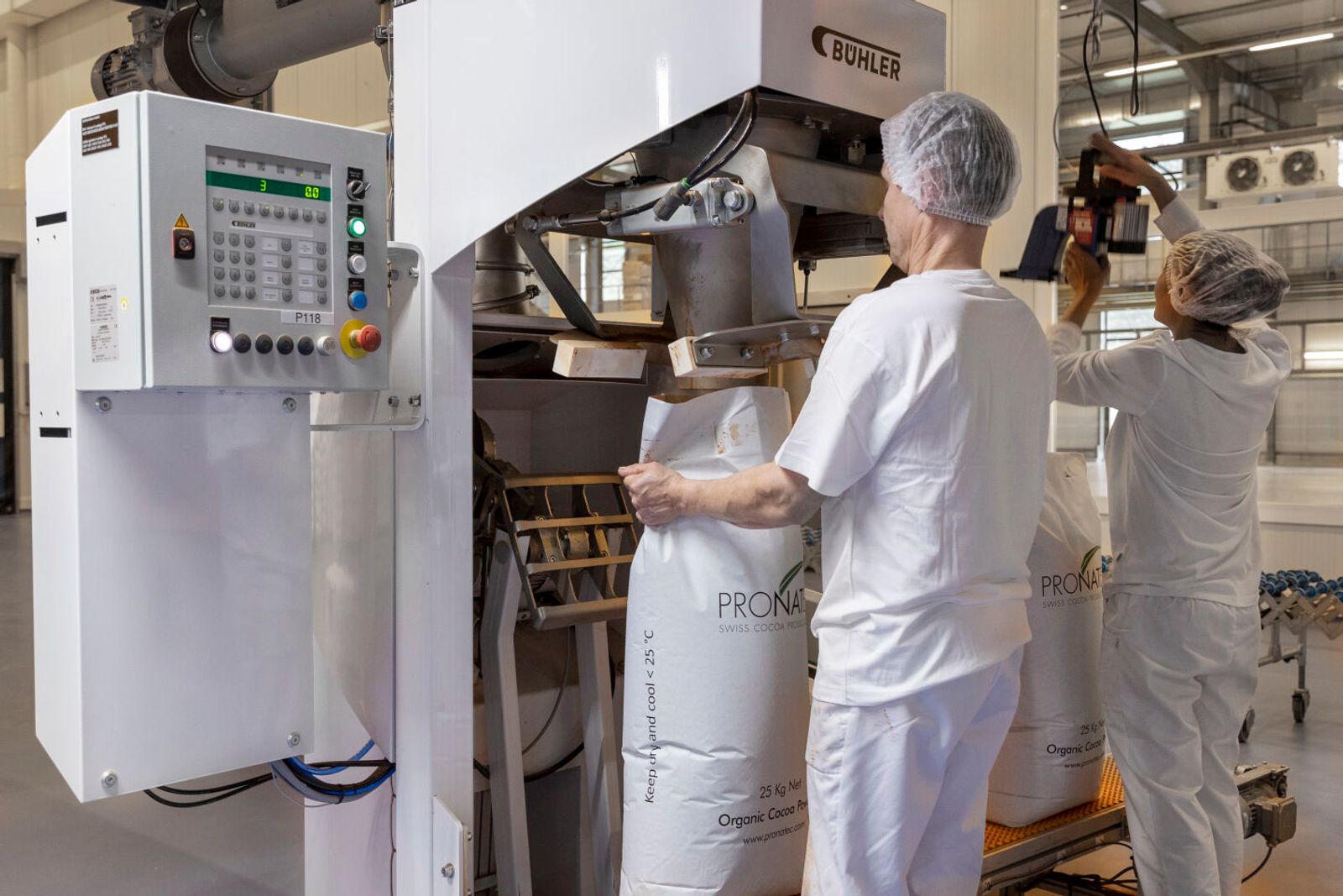 Pronatec employees pack the cocoa powder into bags.